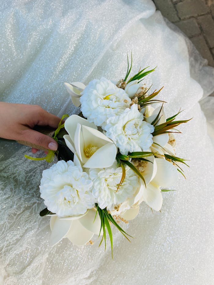 Elegant bridal bouquet featuring white flowers and greenery, perfect for weddings.